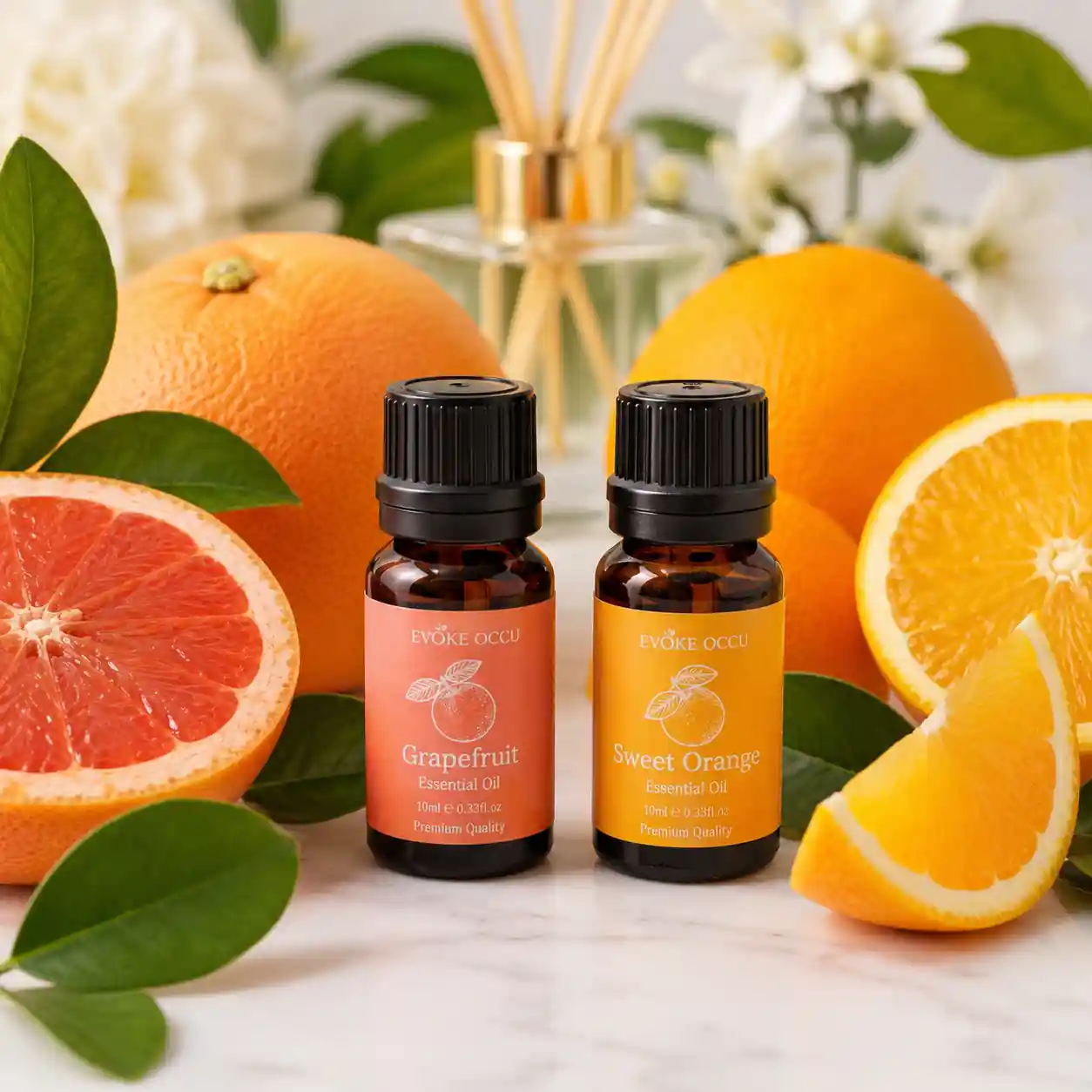Orange and grapefruit essential oils displayed with ingredients commonly used in energizing blends.