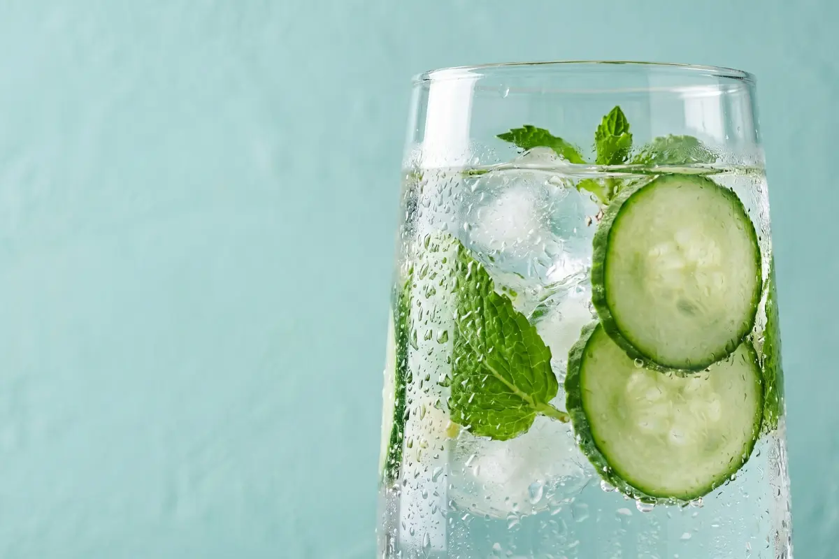 Glass pitcher of infused detox water prepared for a flat belly hydration routine
